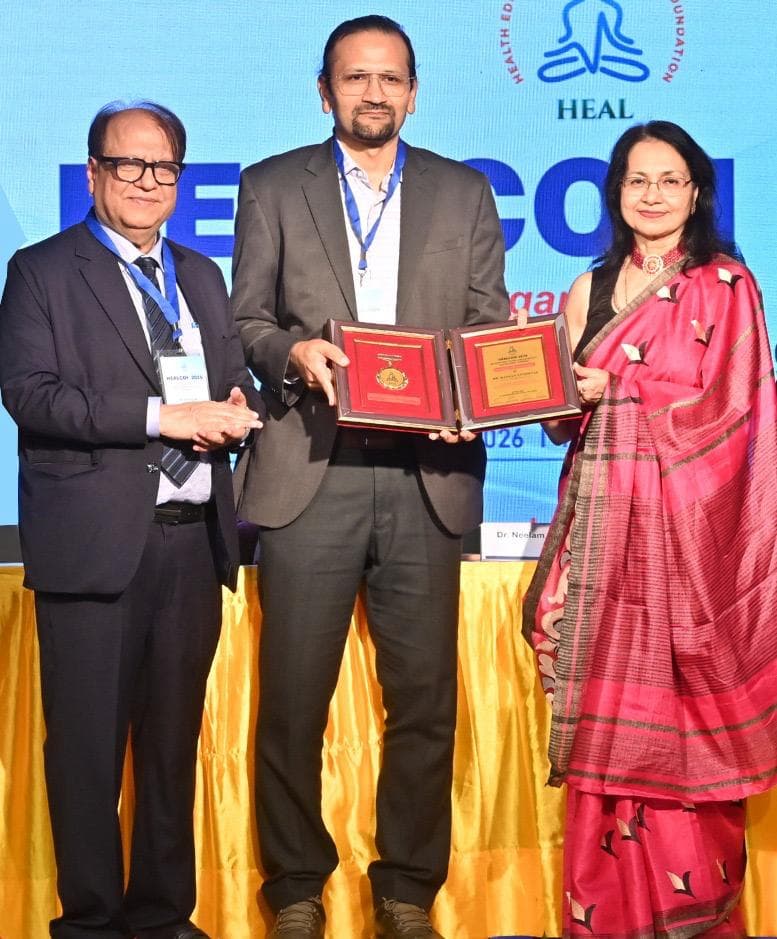 Receiving the award plaque at HEALCON 2026